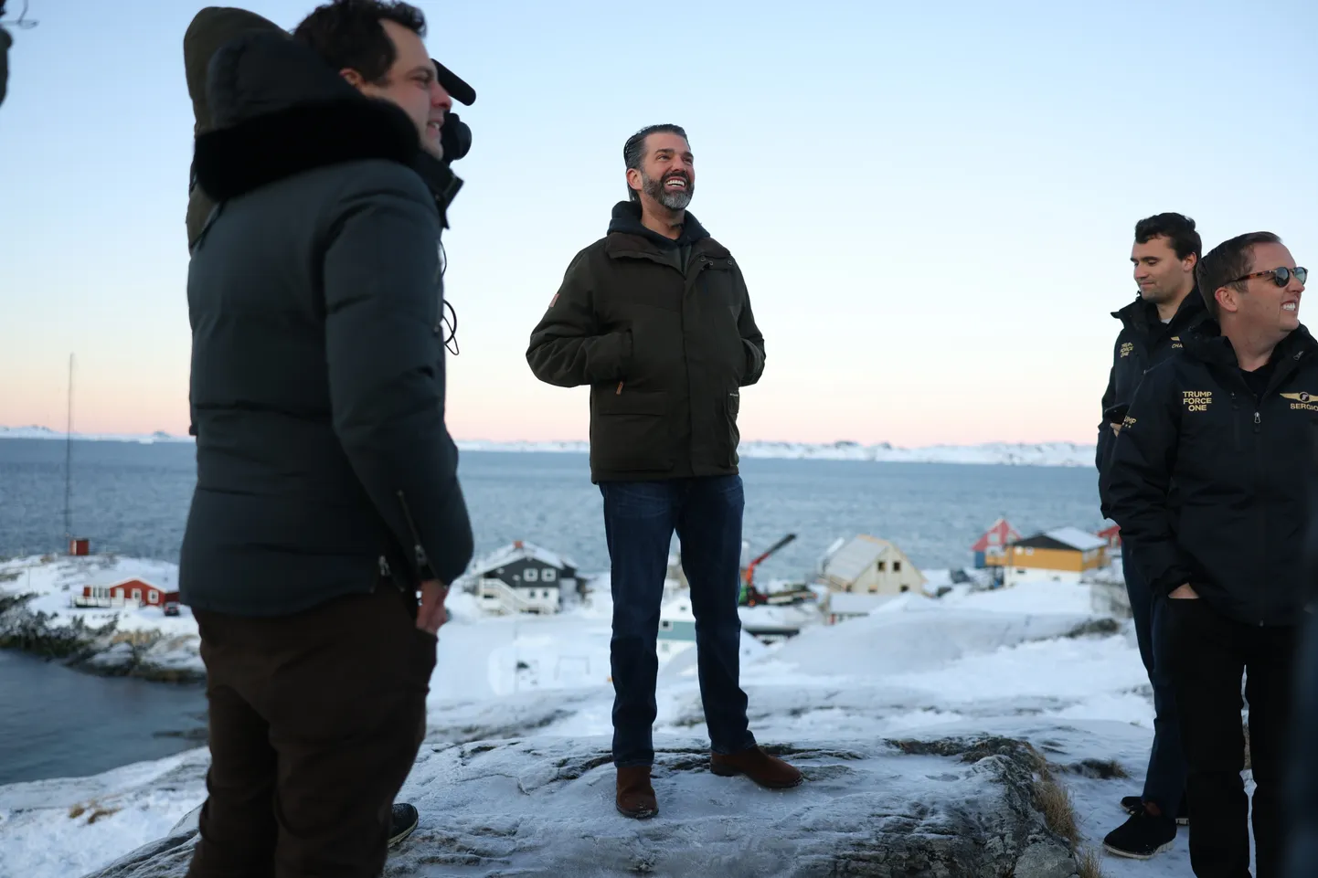 Donald Trump Jr., center, smiles after arriving in Nuuk, Greenland, Tuesday, Jan. 7, 2025. (Emil Stach/Ritzau Scanpix via AP)  TH801