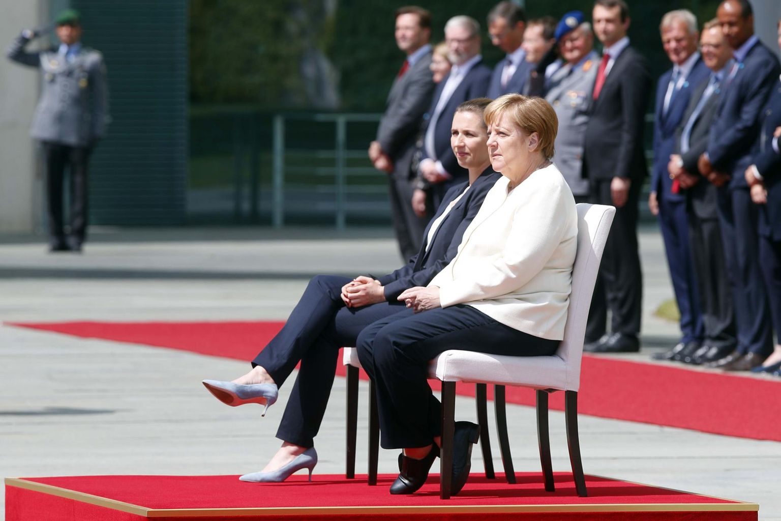 Eilsel tseremoonial jäid Merkel ja Taani peaminister Mette Frederiksen hümnide ajal istuma.
