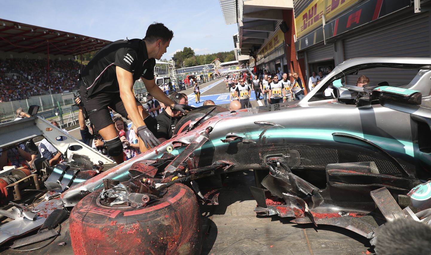 Pit crew inspect the damaged car of Mercedes driver Lewis Hamilton of Britain after Hamilton hit a barrier during the third practice session ahead of the Belgian Formula One at Spa-Francorchamps, Belgium, Saturday, Aug. 31, 2019. The Belgian Formula One race will take place on Sunday. (AP Photo/Francisco Seco)