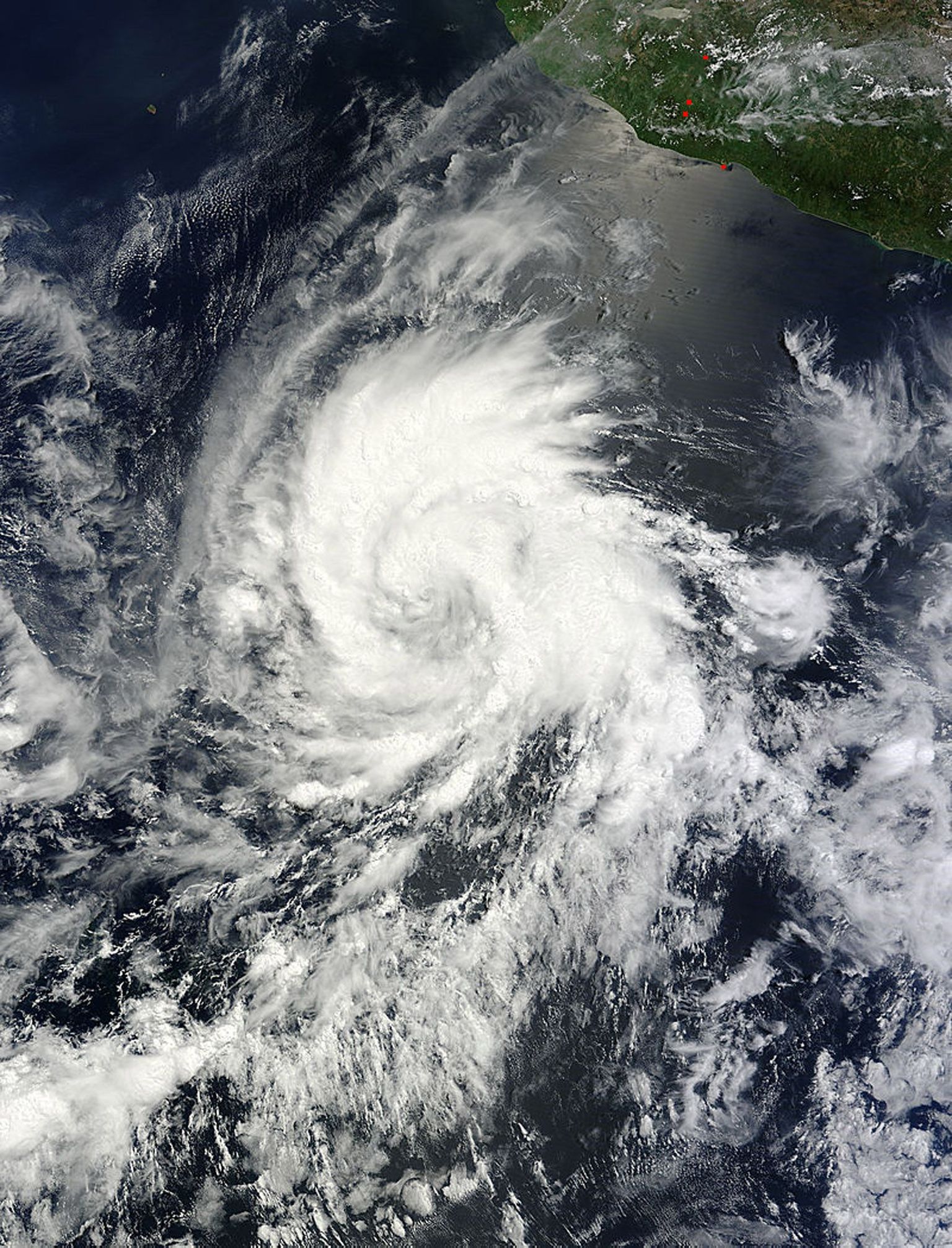 Hurricane Emilia is pictured in the eastern Pacific Ocean when still designated a tropical storm in this July 8, 2012 NASA handout satellite image.Emilia's maximum sustained winds were near 100 mph (160 kmh) and the National Hurricane Center noted that she could become a major hurricane (Category Three) later July 9, 2012. Emilia was located about 710 miles (1145 km) south of the southern tip of Baja California. Emilia is moving at 12 mph (19 kmh) to the west-northwest.   REUTERS/NASA/Handout.     (UNITED STATES - Tags: ENVIRONMENT) THIS IMAGE HAS BEEN SUPPLIED BY A THIRD PARTY. IT IS DISTRIBUTED, EXACTLY AS RECEIVED BY REUTERS, AS A SERVICE TO CLIENTS. FOR EDITORIAL USE ONLY. NOT FOR SALE FOR MARKETING OR ADVERTISING CAMPAIGNS