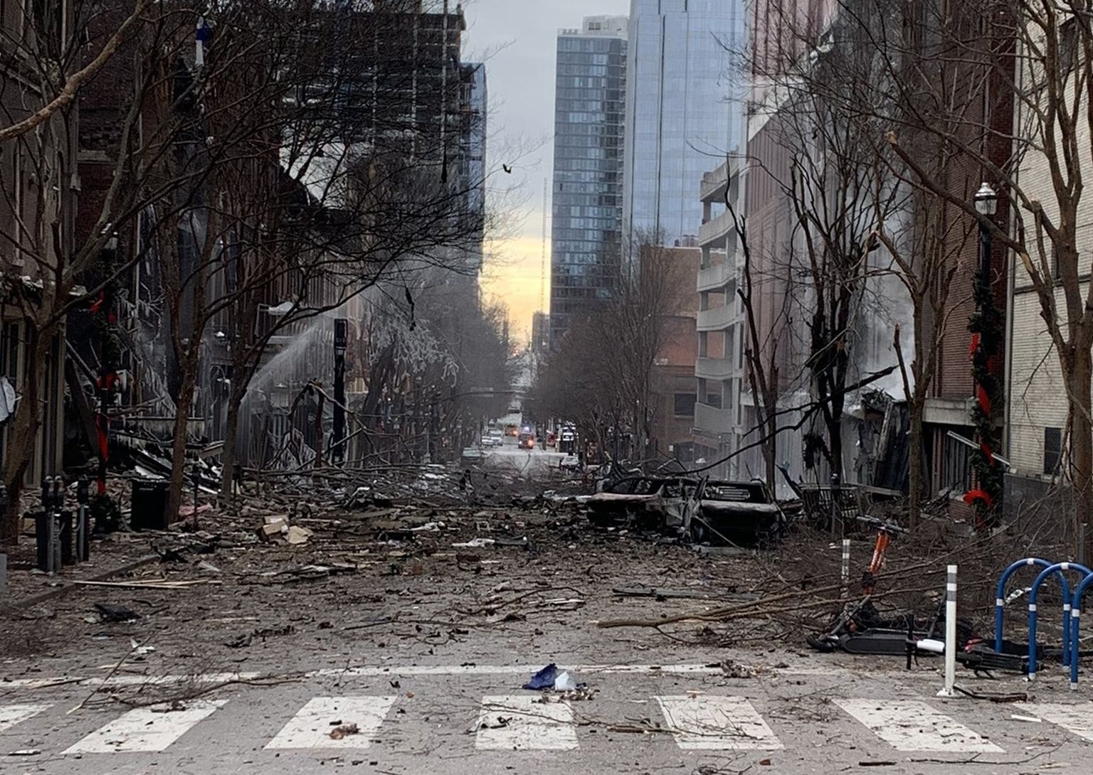 TOPSHOT - In this photo from the Twitter page of the Metro Nashville Police Department, damage is seen on a street after an explosion in Nashville, Tennessee on December 25, 2020. - Officials believe that a Christmas morning explosion in downtown Nashville was an intentional act, according to a Metro Nashville Police spokesman Don Aaron. (Photo by Handout / Metro Nashville Police Department / AFP) / RESTRICTED TO EDITORIAL USE - MANDATORY CREDIT "AFP PHOTO / HO/ Twitter/ Metro Nashville Police Department" - NO MARKETING - NO ADVERTISING CAMPAIGNS - DISTRIBUTED AS A SERVICE TO CLIENTS