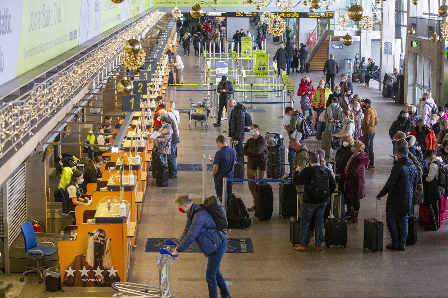 Cilvēku rindas Starptautiskās lidostas "Rīga" pasažieru terminālī.