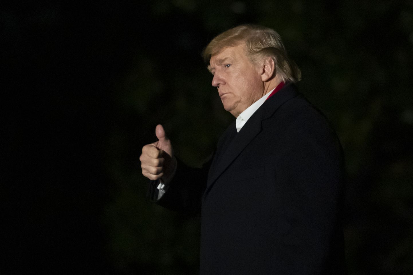 President Donald Trump gives a thumbs-up while walking on the South Lawn as he returns to the White House, early Friday, Jan. 31, 2020, in Washington. Trump returned from trips to Michigan and Iowa. (AP Photo/Alex Brandon)