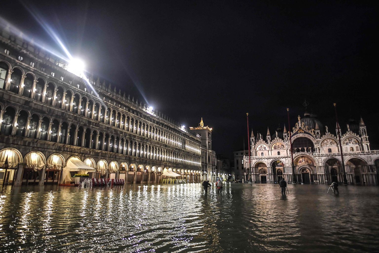 The flooded Piazza San Marco square, with the San Marco Basilica are pictured during an exceptional "Alta Acqua" high tide water level on November 12, 2019 in Venice. - Powerful rainstorms hit Italy on November 12, with the worst affected areas in the south and Venice, where there was widespread flooding. Within a cyclone that threatens the country, exceptional high water were rising in Venice, with the sirocco winds blowing northwards from the Adriatic sea against the lagoons outlets and preventing the water from flowing back into the sea. At 22:40pm the tide reached 183 cm, the second measure in history after the 198 cm of the 1966 flood. (Photo by Marco Bertorello / AFP)