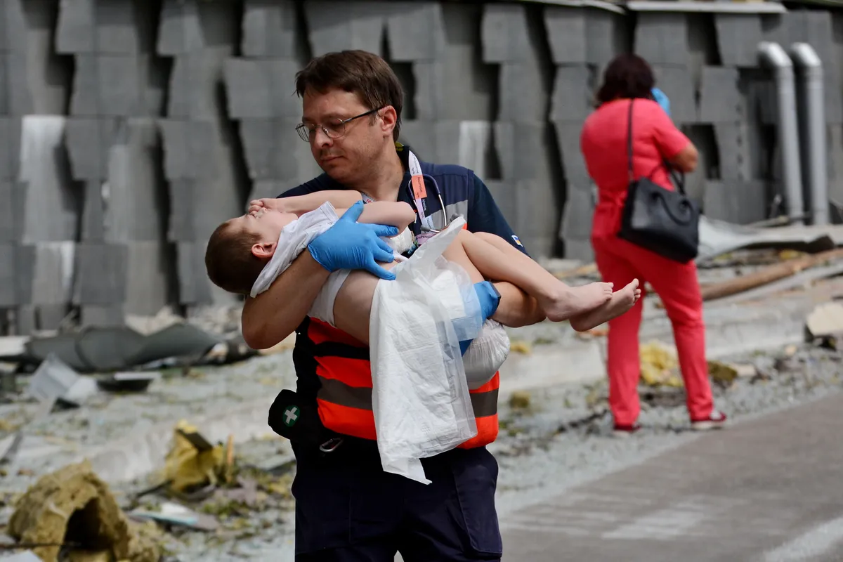 A doctor from Ohmatdyt Children's Hospital carrying out a child who was injured in a Russian missile strike on July 8, 2024.