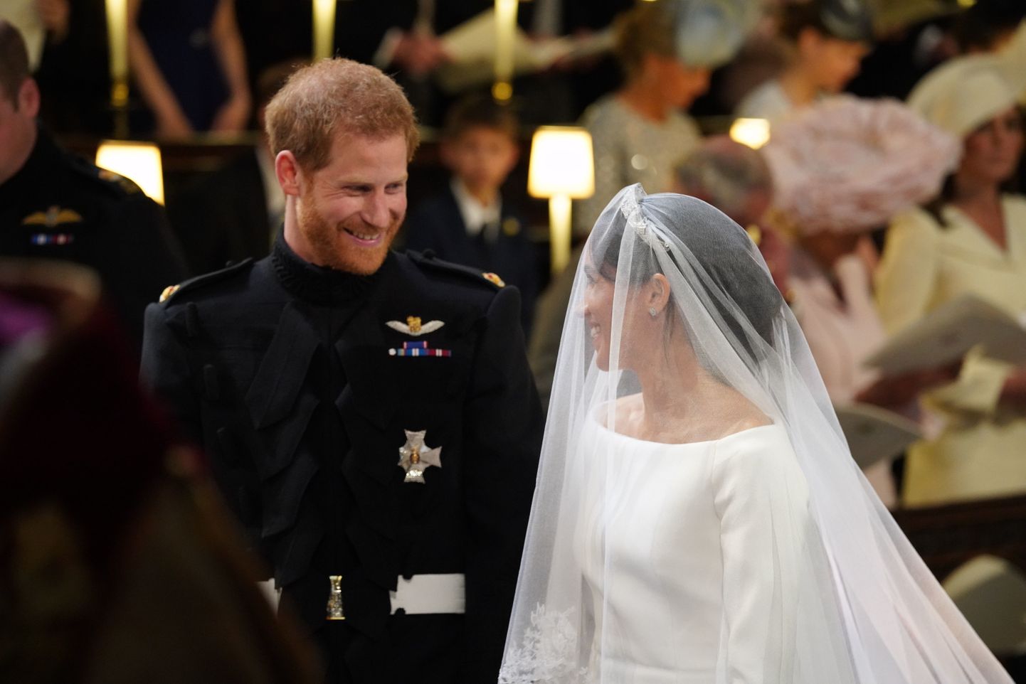 Prince Harry looks at his bride, Meghan Markle, as she arrives accompanied by the Prince of Wales in St George's Chapel at Windsor Castle for their wedding.